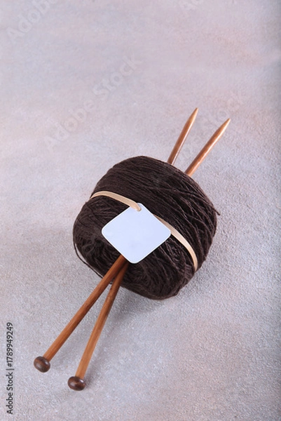 Fototapeta Brown wool yarn for hand knitting. Wooden spokes made of bamboo. Multi-colored wool yarn. Yarn on bobbins. Handmade products. Hobby concept.