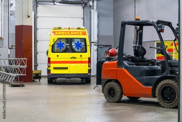 Fototapeta Ambulance vehicle positioned inside the venue, prepared for emergency response during the event