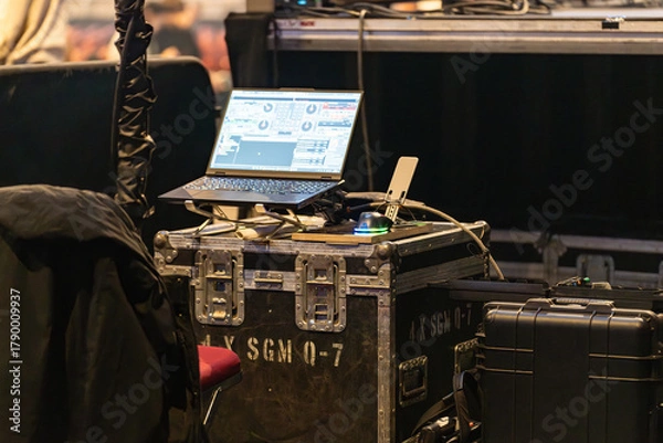 Fototapeta Sound and lighting engineers equipment set up in a concert venue before the show, ready for managing audio and visual effects during the performance