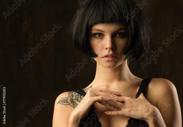 Fototapeta Young brunette with a piercing meaningful gaze. Natural skin without retouch.