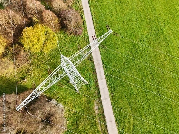 Fototapeta Aerial View of High Voltage Power Line Tower in Green Landscape