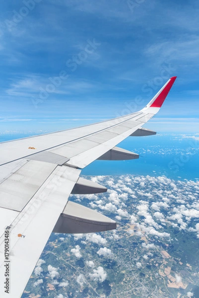 Fototapeta Awesome view of the Earth under the airplane wing