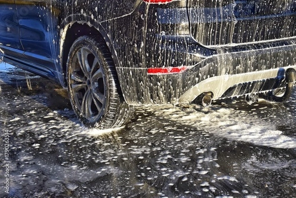 Fototapeta Car in foam at the car wash.