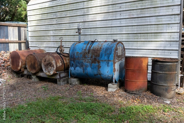 Obraz Fuel barrels and tanks alongside a building