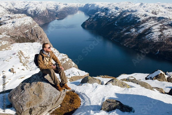 Fototapeta Man Enjoying Scenic Fjord View in Winter