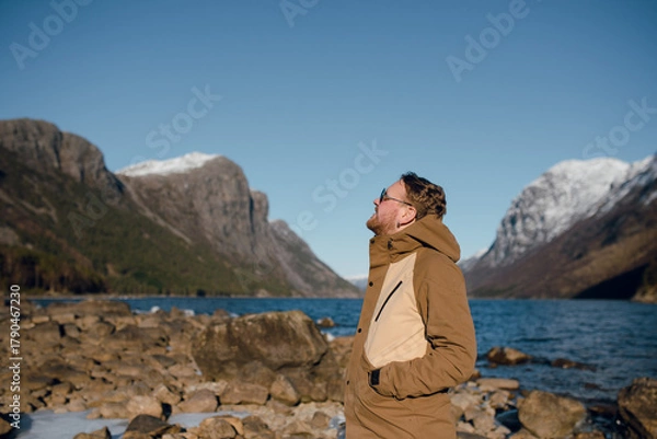 Fototapeta Man Enjoying Scenic Mountain Lakeside View