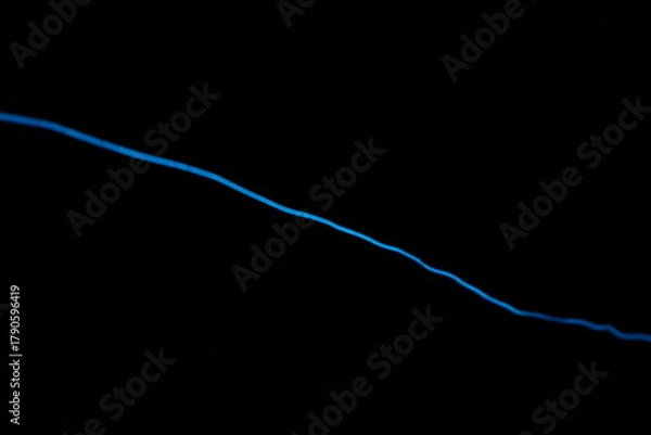 Obraz Minimalist abstract background with a single glowing blue neon line on a pure black backdrop. Simple futuristic design element. Blue laser abstract matrix background 