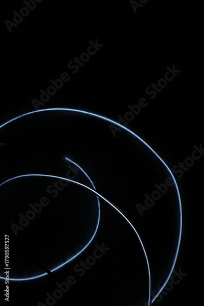 Obraz Minimalist abstract background with a single glowing blue neon line on a pure black backdrop. Simple futuristic design element. Blue laser abstract matrix background 