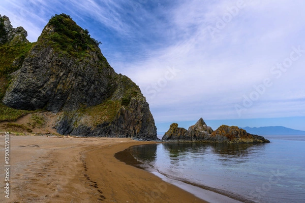 Fototapeta Explore the serene coastline of Russia with towering cliffs and tranquil waters