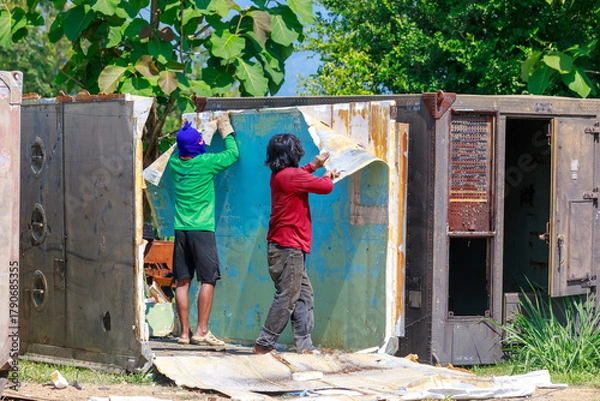 Obraz Construction Workers Dismantling and Recycling Old Container Panels Outdoors