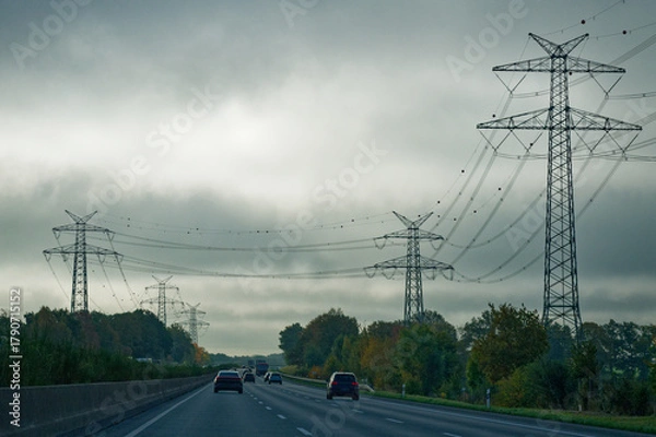 Obraz German Highway Autobahn with cars and Nordlink power pylons lining both sides
