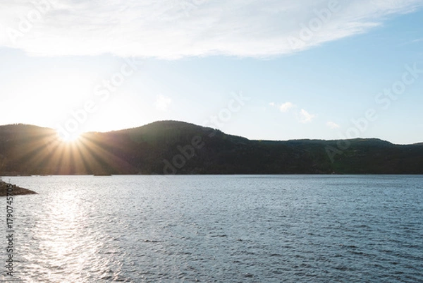 Obraz Golden light over calm lake in Setesdal Valley, Norway. Gentle hills and still water reflect warm sunset tones, capturing peaceful essence of Norwegian wilderness