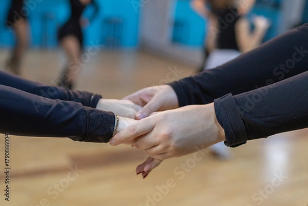 Obraz students holding hands in dancing during class in a bright studio