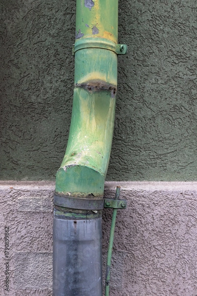 Obraz Weathered green drainpipe on textured exterior wall
