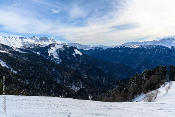 Fototapeta Panoramic view of the highlands, valley, forest and snowy slopes.