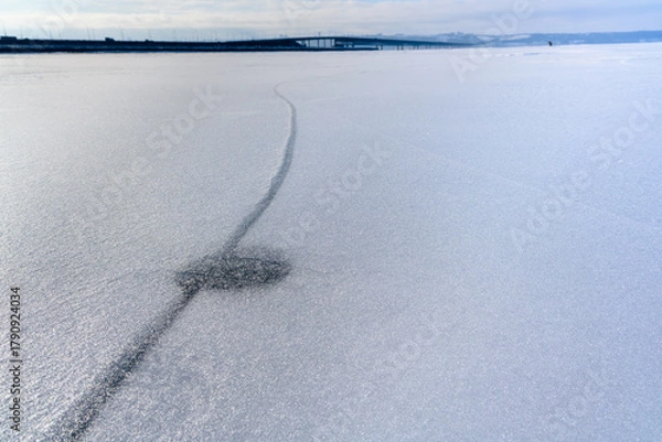 Fototapeta A huge crack in the frozen Volga River at its widest and deepest point near Ulyanovsk.