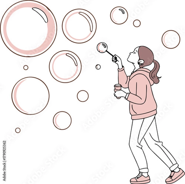Obraz Joyful young girl creating magical floating bubbles with a wand and cheerful expression outdoors