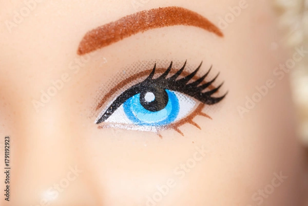 Fototapeta Part of the face with an eye of a plastic children's doll.