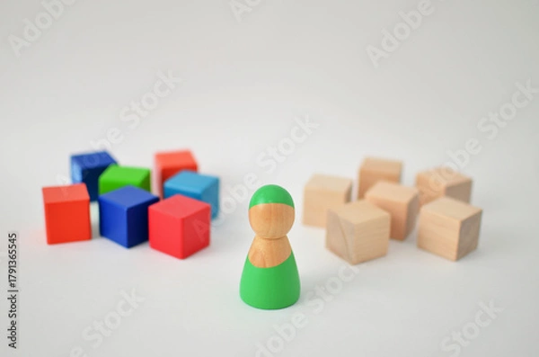 Obraz Wooden figure choosing between diverse and uniform groups