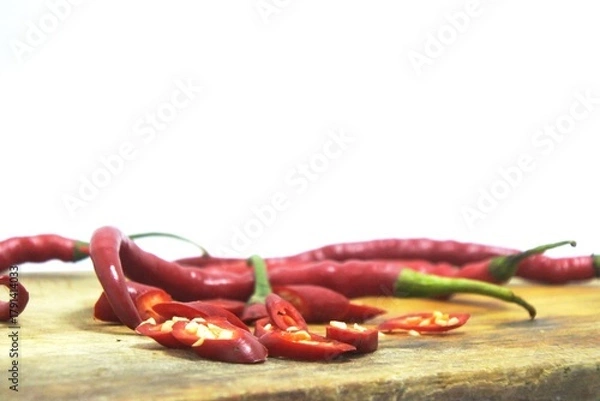 Obraz The fresh curly red chilies or capsicum annuum on an old wooden cutting board