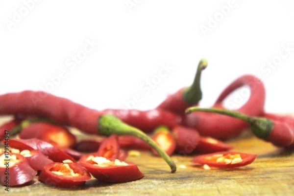 Obraz The fresh curly red chilies or capsicum annuum on an old wooden cutting board