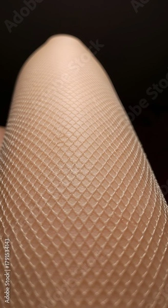 Obraz Close-up of a leg wearing textured stockings, showcasing intricate diamond pattern against skin.