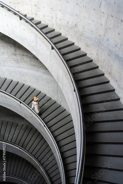 Fototapeta Elegant Spiral Staircase with a Woman in a Hat