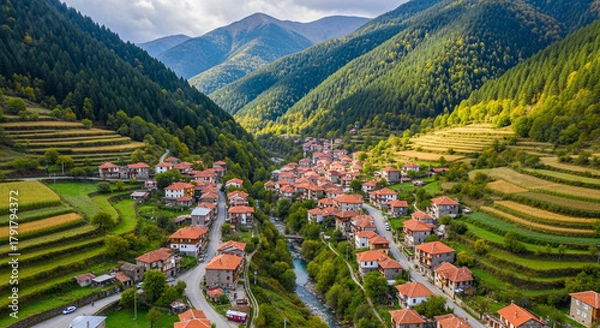 Fototapeta Aerial view of the picturesque village of kosovo in the rhodope mountains, bulgaria, showcasing traditional houses, terraced fields, and stunning mountain scenery