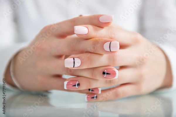 Obraz Beautiful female hands with a fashionable manicure. Geometric design of nails. Photo closeup