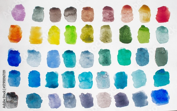 Obraz A variety of watercolor palettes of warm  and cool shades on a white paper background.