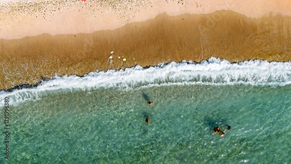 Fototapeta Aerial drone view of sandy beach and turquoise sea waves with people sunbathing, swimming and relaxing, holiday vacation concept, Antalya Konyaalti beach, Turkey