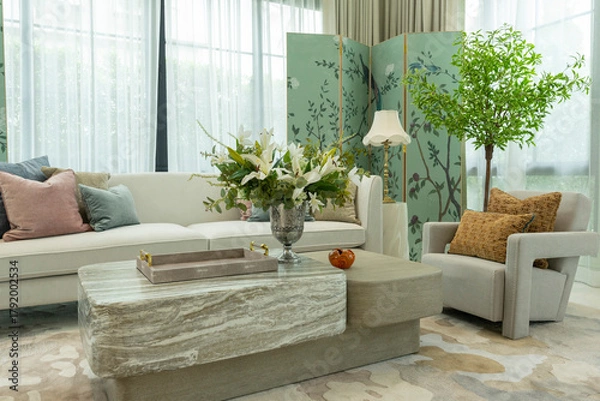 Obraz Interior of a luxurious sitting room with bay window sofas and coffee table. White and green tone of vast luxury living room.
