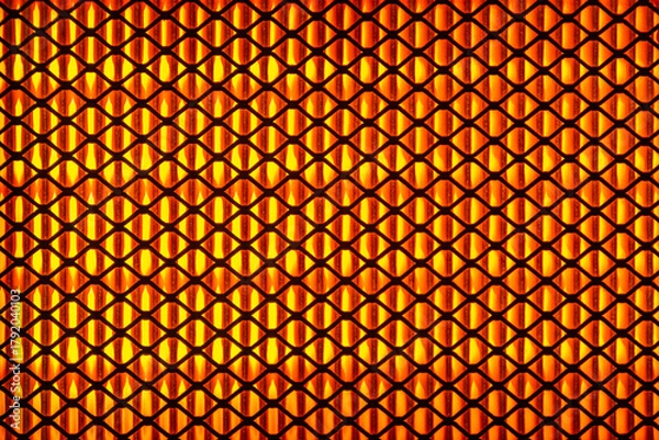 Fototapeta A close-up of the grill. The hot grill is orange.