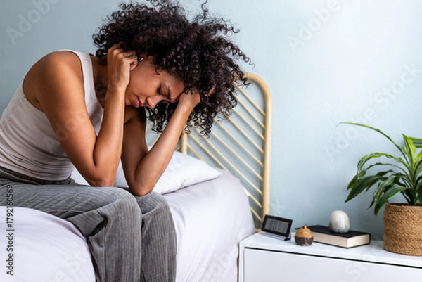 Obraz Woman experiencing stress, headache, and insomnia in bedroom