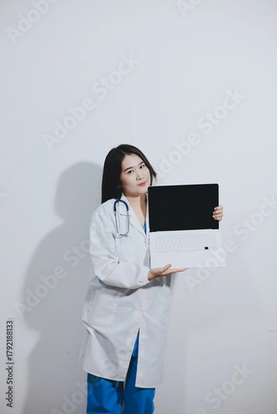 Fototapeta Female druggist standing with a digital tablet