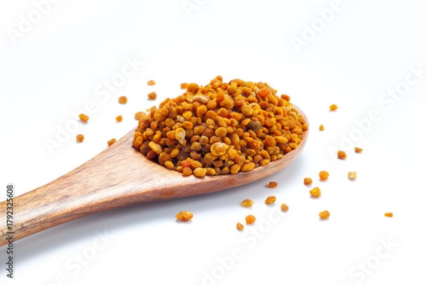 Obraz bee pollen grains in wooden spoon isolated on white background