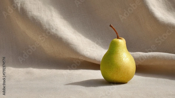 Obraz fresh ripe pear rests elegantly against backdrop of soft linen fabric illuminated by ultrabright sunlight