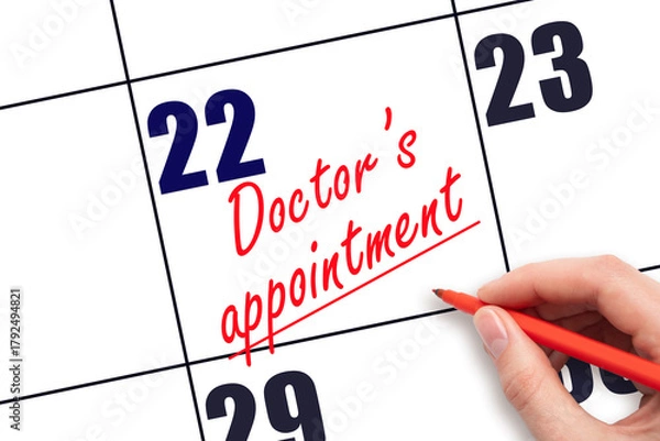 Fototapeta 22 nd day of the month. Hand writing Doctor's appointment reminder and drawing a line on calendar with red pen on white background. Health care concept. Planning and scheduling