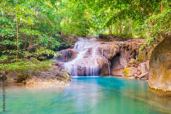 Obraz Tropical landscape with beautiful waterfall, wild rainforest with green foliage and flowing water. Erawan National park, Kanchanaburi, Thailand