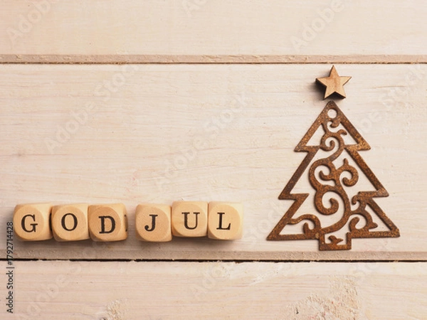 Obraz God Jul on wooden cubes, Scandinavian christmas background with a rusty Christmas tree shape