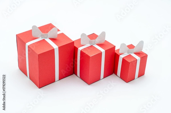 Obraz Three miniature red gift boxes on the white background