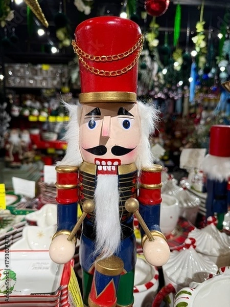 Obraz Nutcracker soldier drummer standing as a traditional christmas holiday decoration with red hat, blue uniform, white beard and gold trim, painted wooden festive figure