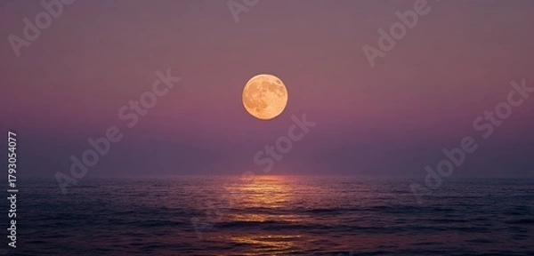 Fototapeta Full moon over water with light reflection and hazy pink/purple sky