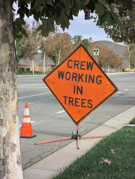 Fototapeta Crew working in trees warning sign on roadway