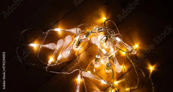 Fototapeta Warm White LED String Lights on Wooden Surface