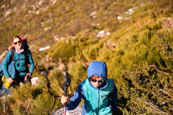 Obraz Mother and her son wearing sunglasses walking in the mountains on a sunny day