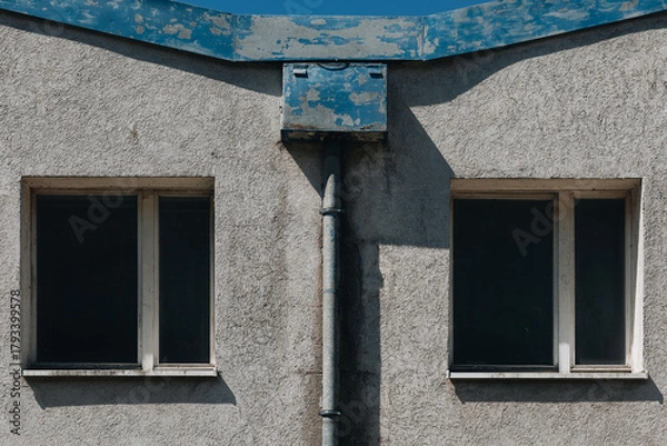 Fototapeta Symmetrical Old Building Facade with Two Dark Windows