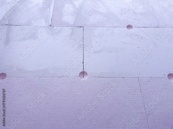 Fototapeta Insulation boards of extruded polystyrene foam (XPS) with anchor holes, showing thermal facade installation and construction texture for energy efficiency and modern architecture.