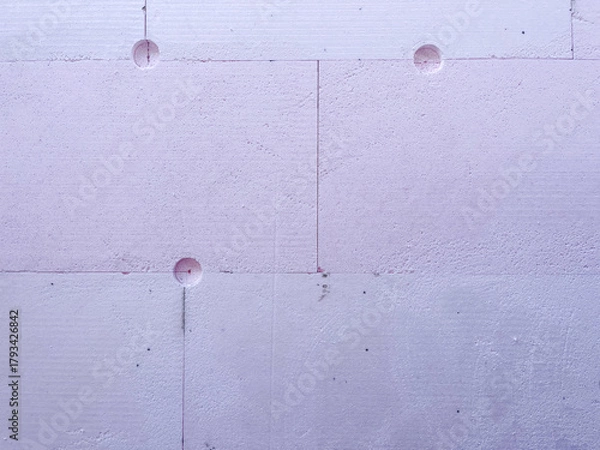 Fototapeta Insulation boards of extruded polystyrene foam (XPS) with anchor holes, showing thermal facade installation and construction texture for energy efficiency and modern architecture.