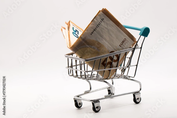 Obraz Fifty Euro Savings Concept: Vibrant 50 Euro Note in Small Supermarket Trolley atop Additional Currency
